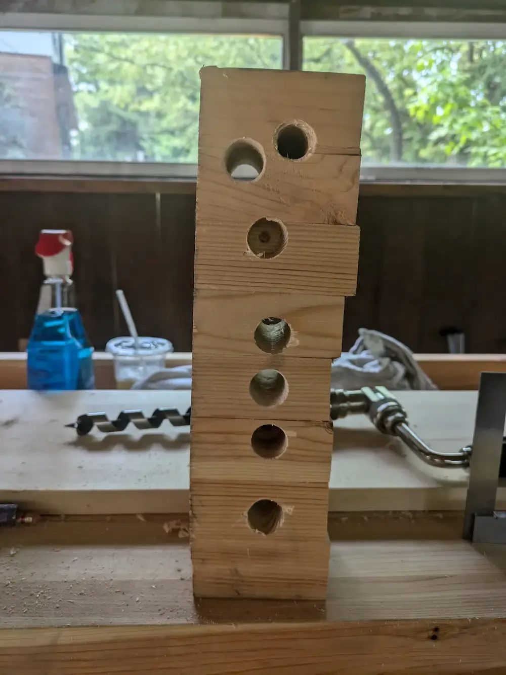 Test holes in a scrap piece of wood